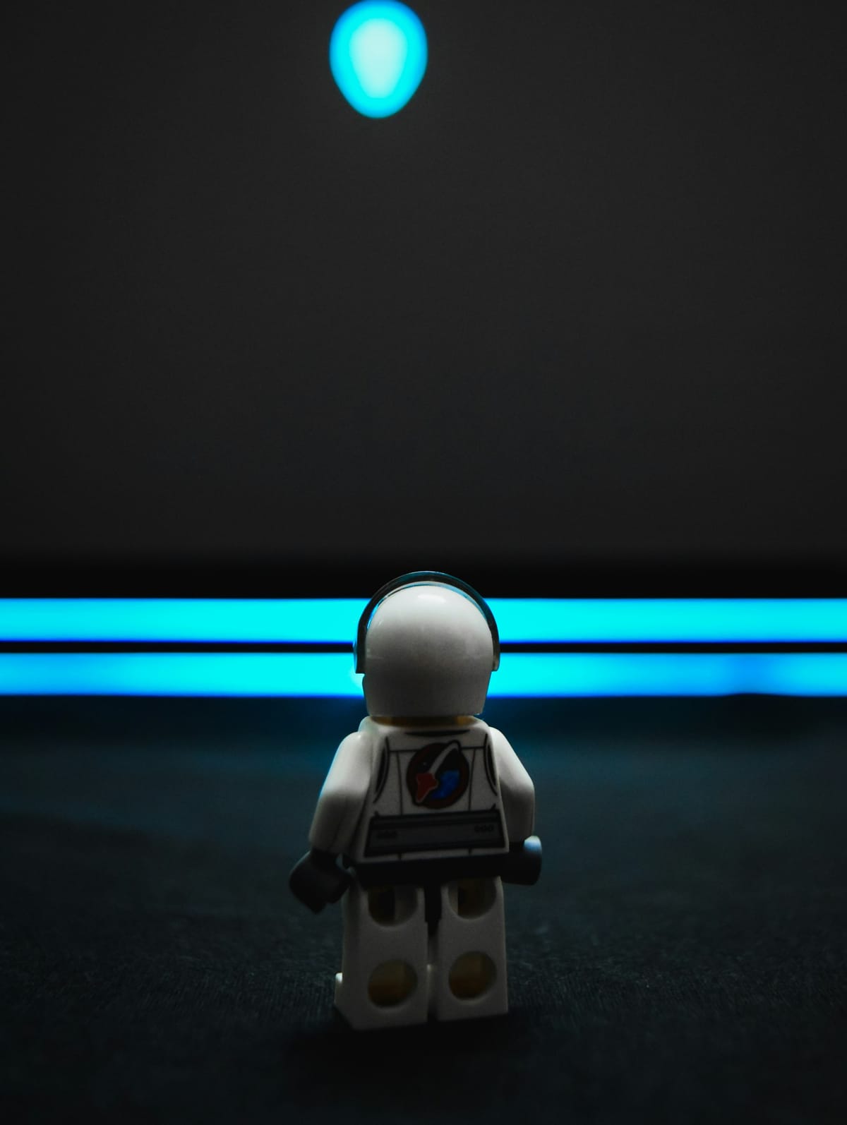 Lego spaceman looking at planet in the distance